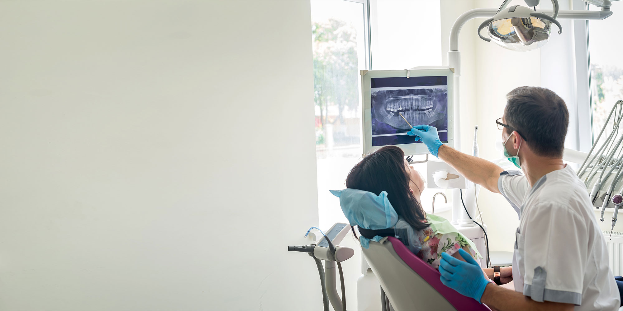 Doctor dentist showing patient's teeth on X-ray