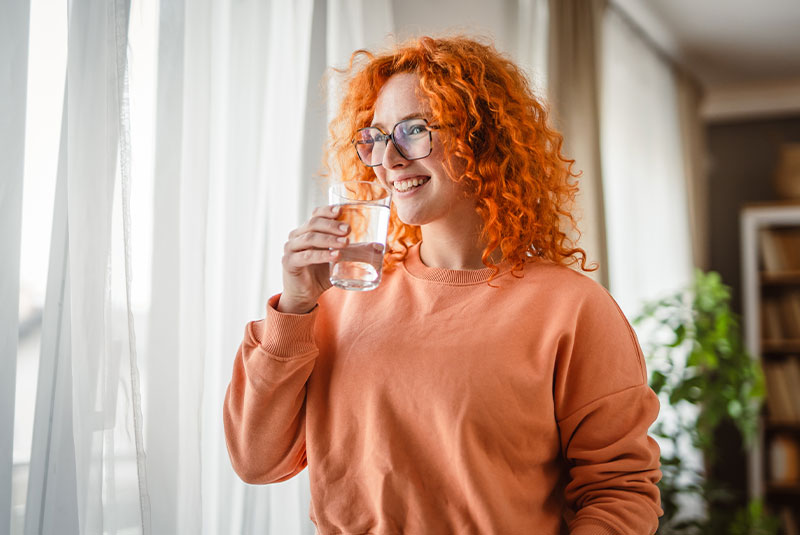portrait of women smiling brightly within the comfort of their own living room