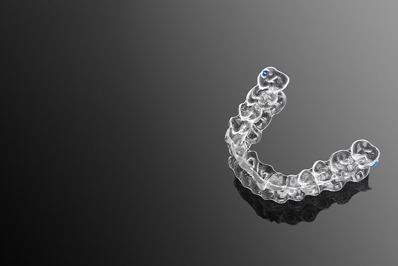 Invisible orthodontics cosmetic brackets on gradient background